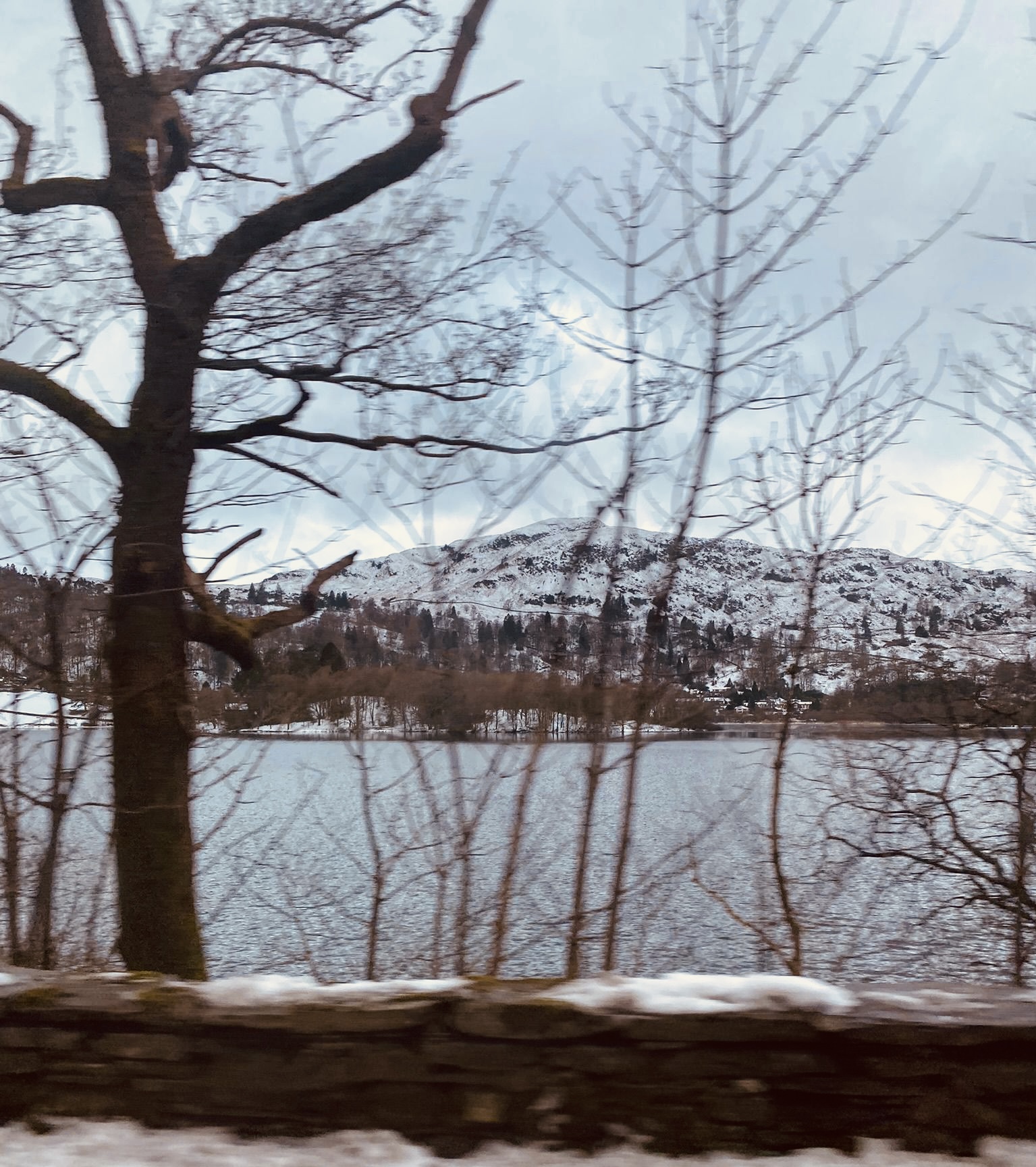 snow capped mountain behind a lake