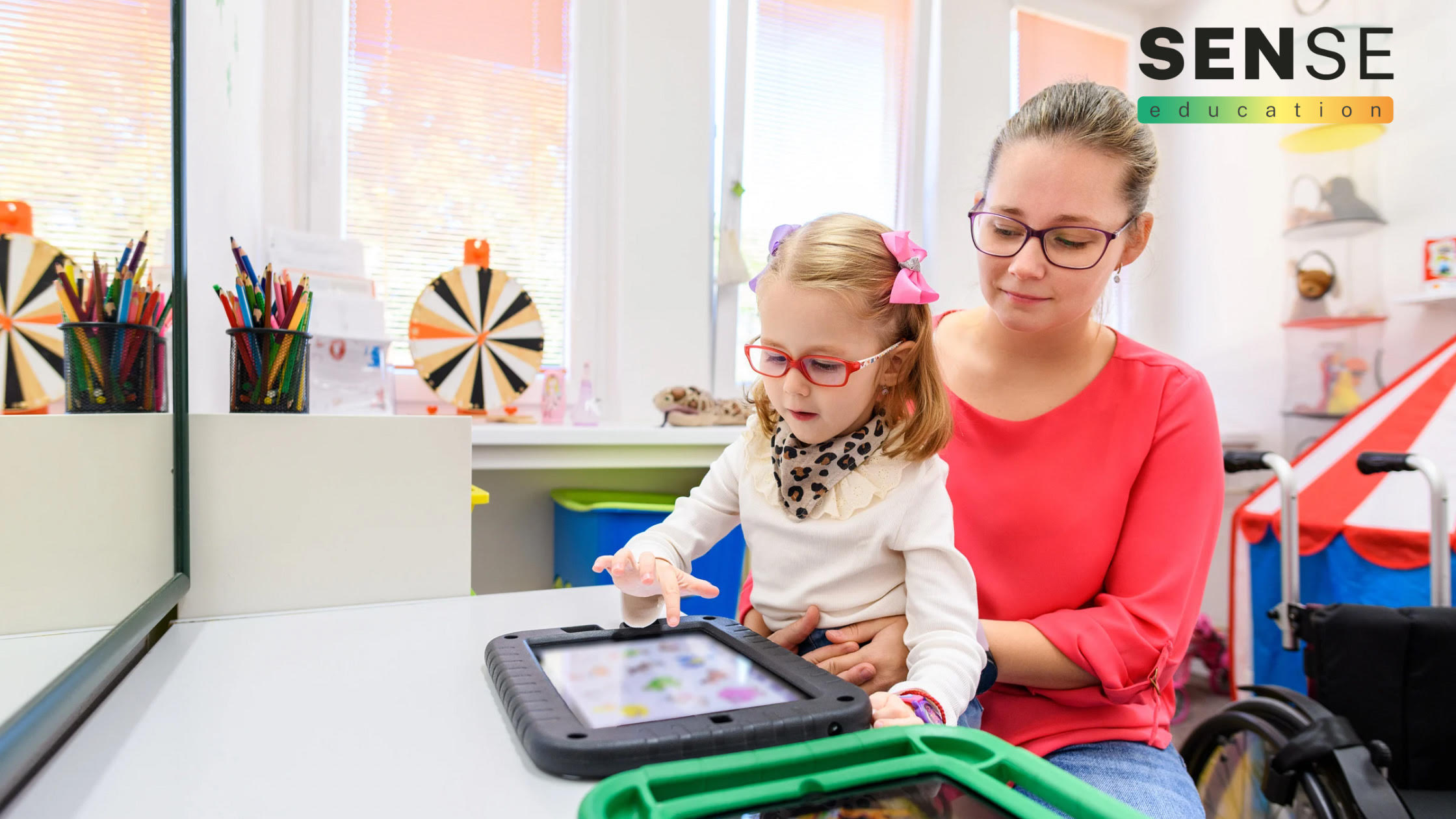 SEND child with teaching assistant in classroom