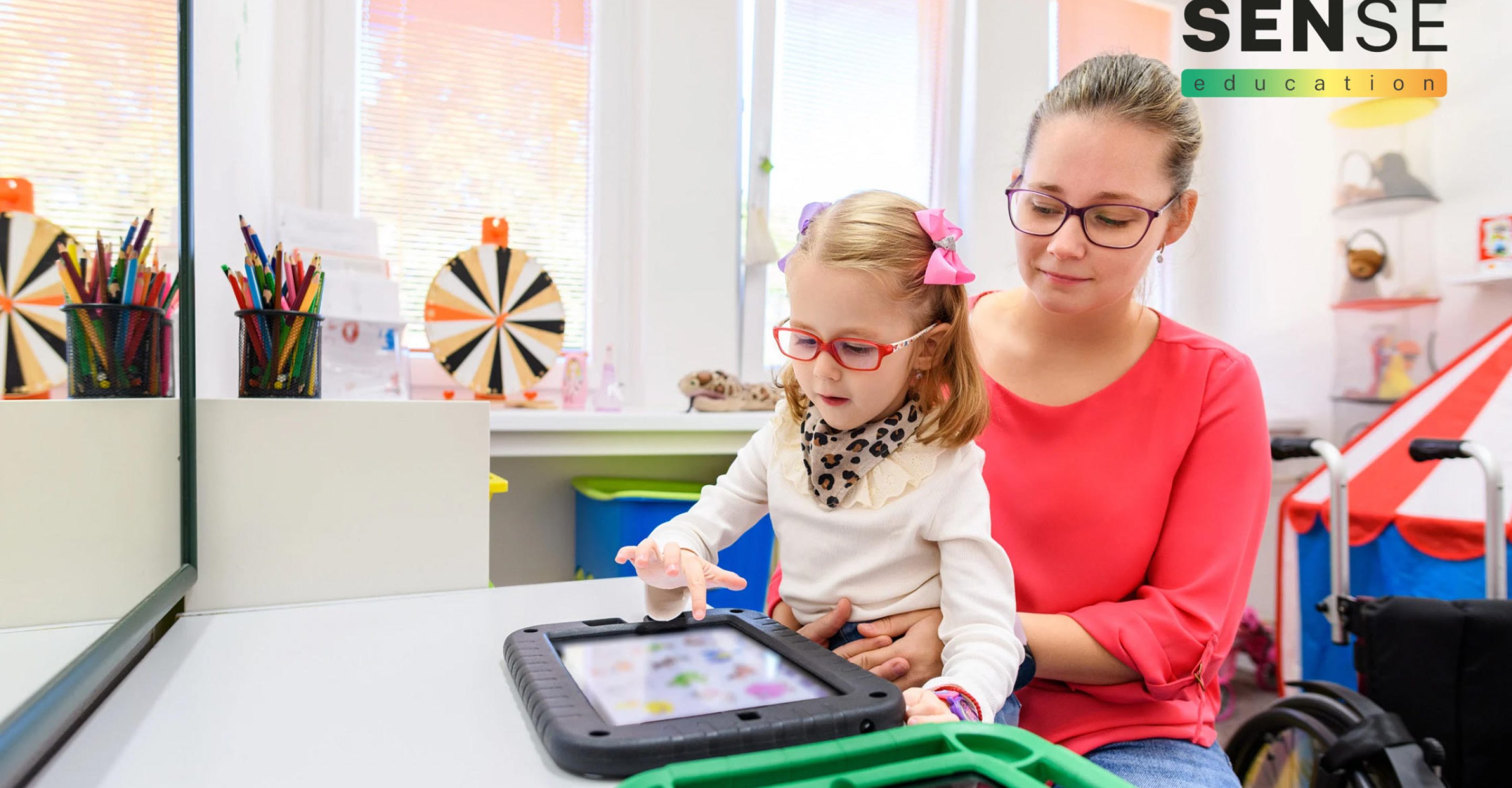 SEND child with teaching assistant in classroom